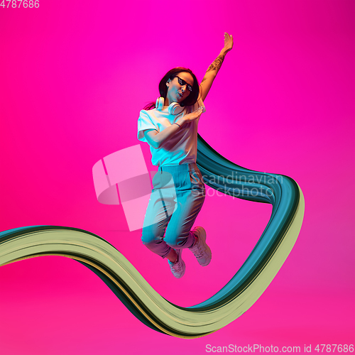 Image of Stylish woman with long fluid flood on gradient background. Negative space to insert your text. Modern design. Contemporary colorful and conceptual bright art collage.