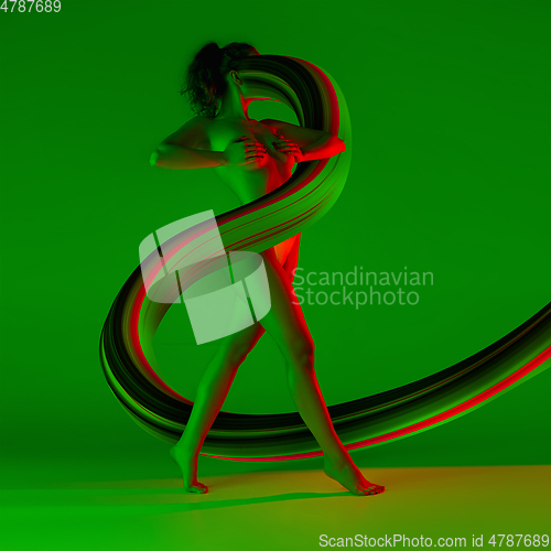 Image of Fit sportive woman with long fluid flood on gradient background. Negative space to insert your text. Modern design. Contemporary colorful and conceptual bright art collage.