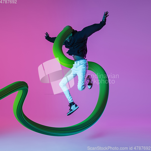 Image of Stylish man with long fluid flood on gradient background. Negative space to insert your text. Modern design. Contemporary colorful and conceptual bright art collage.