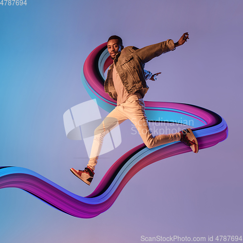 Image of Stylish man with long fluid flood on gradient background. Negative space to insert your text. Modern design. Contemporary colorful and conceptual bright art collage.