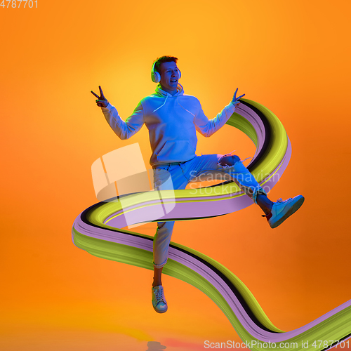 Image of Stylish man with long fluid flood on gradient background. Negative space to insert your text. Modern design. Contemporary colorful and conceptual bright art collage.