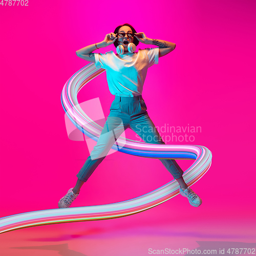 Image of Stylish woman with long fluid flood on gradient background. Negative space to insert your text. Modern design. Contemporary colorful and conceptual bright art collage.