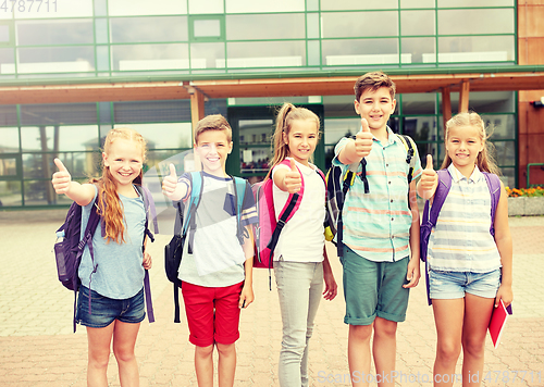 Image of happy elementary school students showing thumbs up