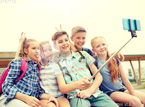 Image of happy elementary school students taking selfie