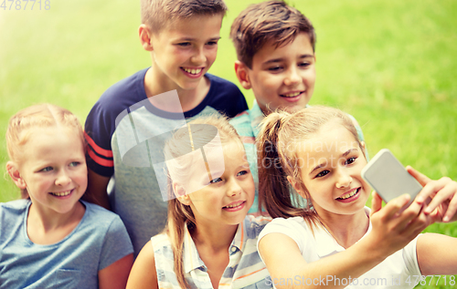 Image of happy kids or friends taking selfie in summer park