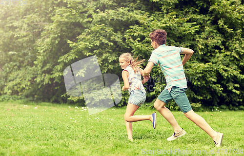 Image of happy kids running and playing game outdoors