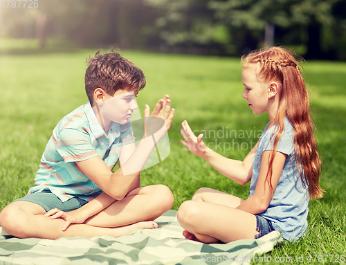 Image of happy kids playing rock-paper-scissors game