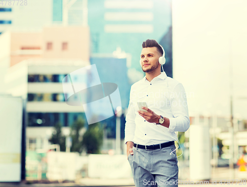 Image of man with headphones and smartphone listening music