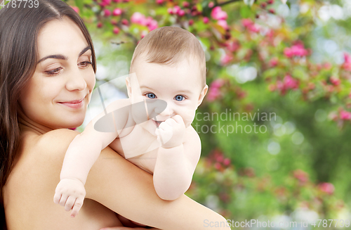 Image of mother with baby over spring garden background