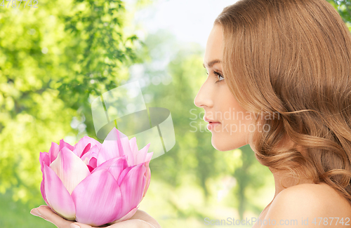 Image of beautiful woman with pink lotus flower