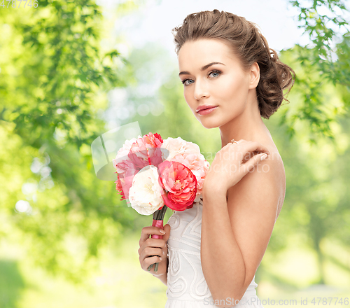 Image of young woman or bride with bouquet of flowers