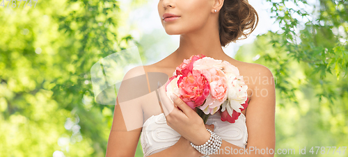 Image of young woman or bride with bouquet of flowers