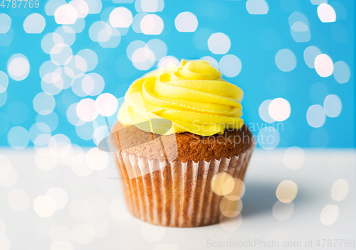 Image of close up of cupcake or muffin with yellow frosting