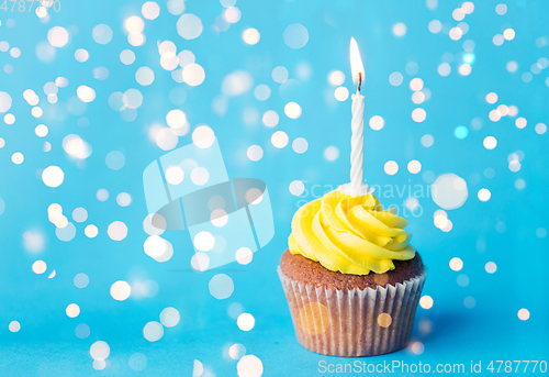 Image of birthday cupcake with one burning candle