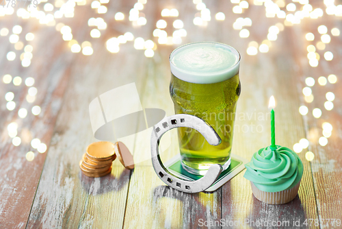 Image of glass of beer, cupcake, horseshoe and gold coins