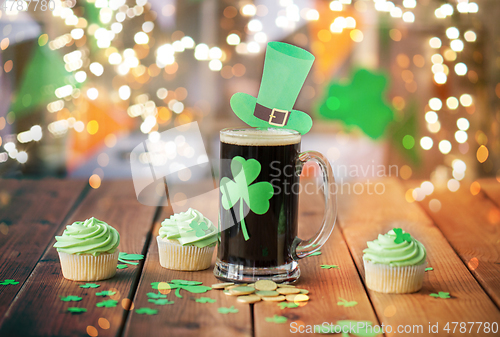 Image of shamrock on beer glass, green cupcakes and coins