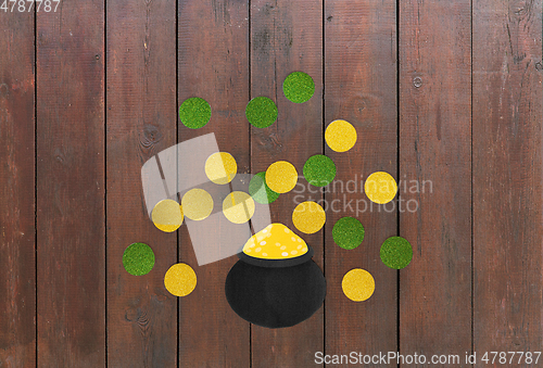 Image of pot of gold and coins for st patricks day on wood