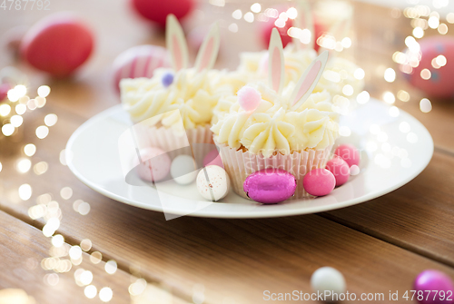 Image of cupcakes with easter eggs and candies on table