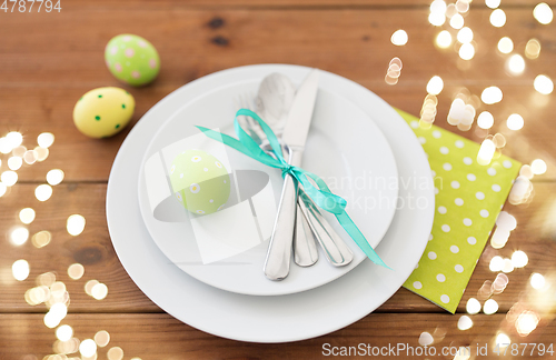 Image of easter egg in cup holder, plates and cutlery