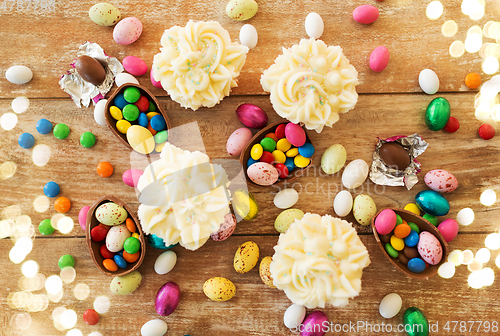 Image of cupcakes with chocolate eggs and candies on table