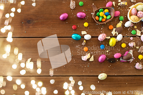 Image of chocolate eggs and candy drops on wooden table