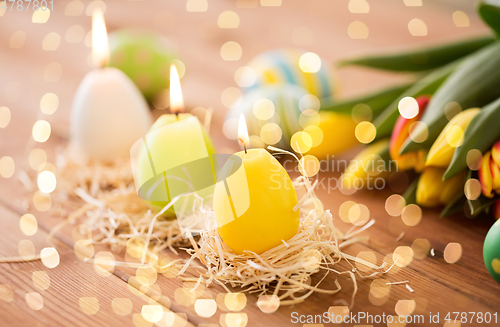 Image of candles in shape of easter eggs and tulip flowers