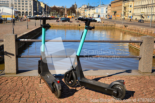 Image of Two Electric Scooters Parked in City