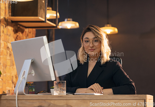 Image of Businesswoman, manager working in modern office using devices and gadgets