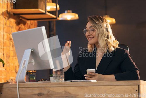 Image of Businesswoman, manager working in modern office using devices and gadgets