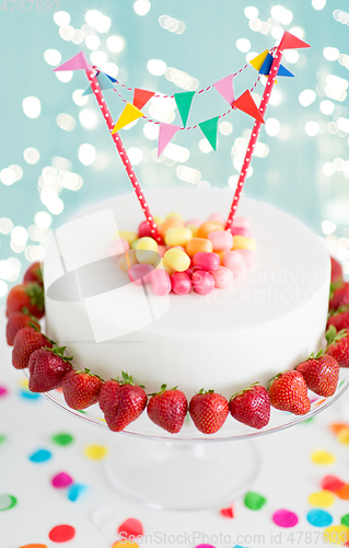 Image of close up of birthday cake with garland on stand