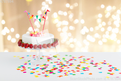 Image of close up of birthday cake with garland on stand