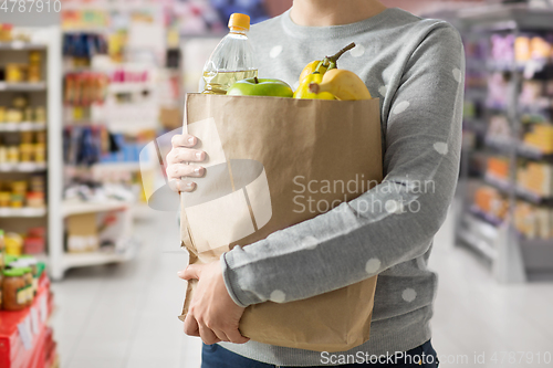 Image of close up of woman with paper bag full of food