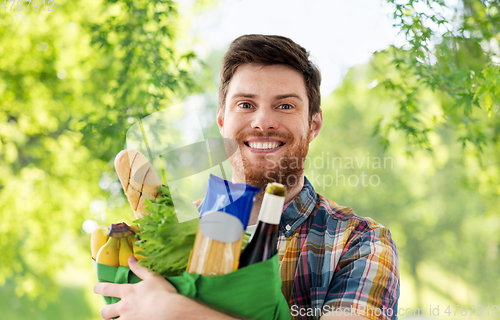 Image of smiling young man with food in bag