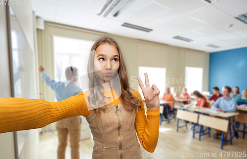 Image of teenage student girl taking selfie at school