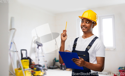 Image of builder with clipboard and pencil having idea