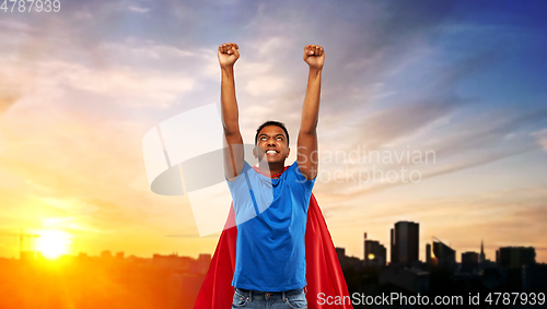 Image of indian man in superhero cape flying in city