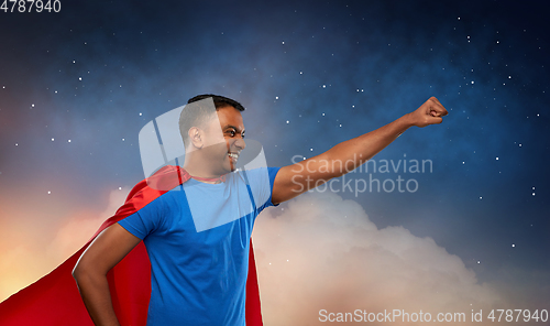 Image of indian man in superhero cape makes winning gesture