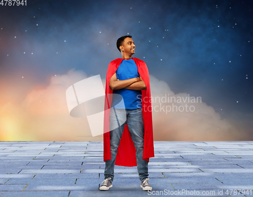 Image of happy smiling indian man in red superhero cape