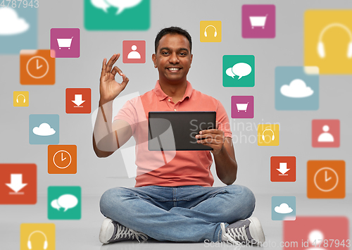 Image of happy indian man with tablet pc over app icons