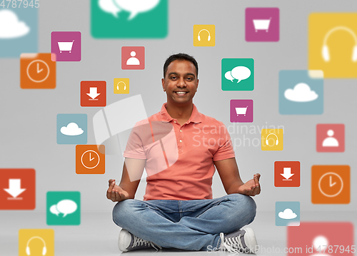 Image of happy man in yoga lotus pose over app icons