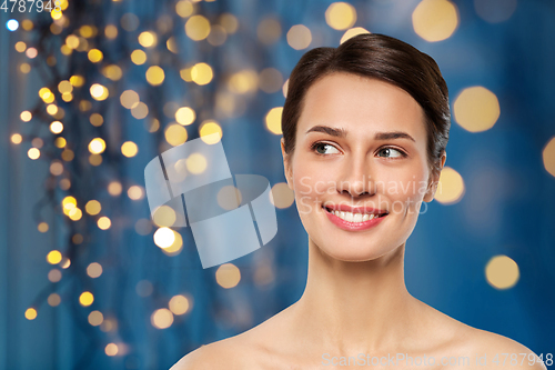 Image of beautiful smiling young woman with bare shoulder