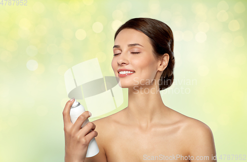 Image of beautiful young woman with facial spray or mist