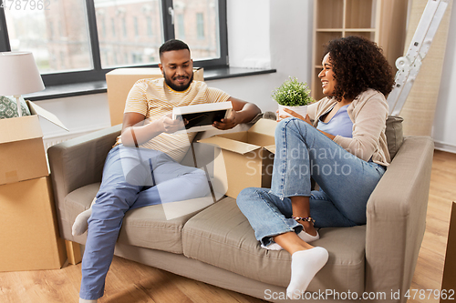 Image of happy couple with boxes moving to new home