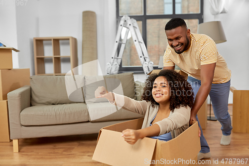 Image of happy couple moving to new home and having fun