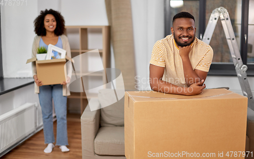 Image of happy couple with boxes moving to new home