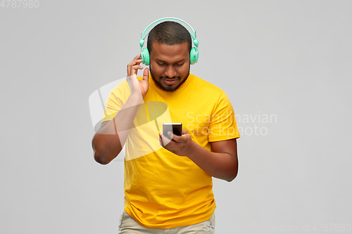 Image of african man with headphones and smartphone