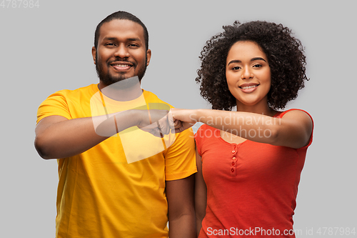 Image of african american couple making fist bump gesture