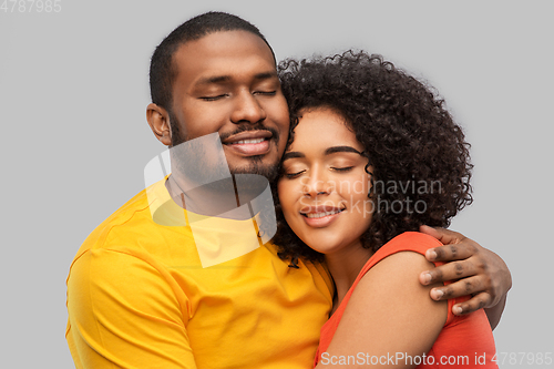 Image of happy african american couple hugging