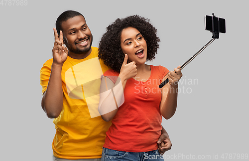 Image of african american couple taking selfie by cellphone