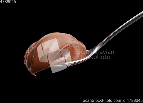 Image of spoon of melted chocolate cream
